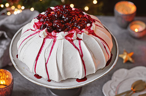 Test your meringue-making skills with this cranberry Pavlova recipe for a stunning Christmas centrepiece