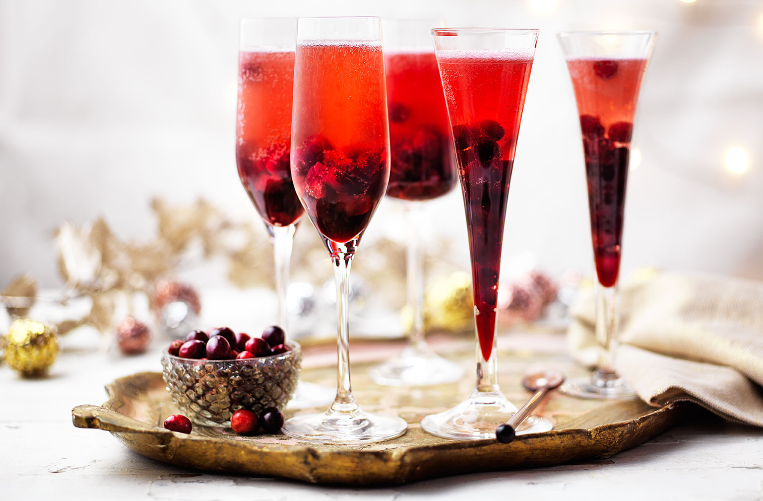 Festive fruit gives this Kir Royale an extra special twist. With a syrup made from fresh cranberries, Crème de Cassis and sugar this Champagne cocktail is the perfect Christmas party idea