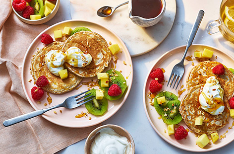 These pancakes are made with wholemeal flour and served with a rainbow assortment of fruit making this breakfast plate a source of fibre. They make a bright and hearty start to the day.