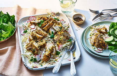 Chicken breasts are coated in a citrussy honey mustard marinade and roasted until golden. They're served atop a bed of slaw made with apple, cabbage and radishes. A light and bright dinner that's super-tasty and healthy too!