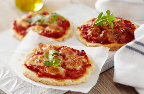 These gluten-free mini pizzas are a great way to get the kids involved in the kitchen. Making the dough from scratch is a lot of fun and each pizza base ends up being crisp and fluffy. Keep things simple with a margherita or your own choice of toppings.