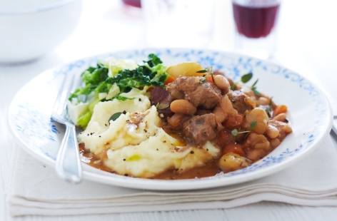 Cassoulet is a gorgeous meaty bean stew with a crisp topping from South-West France. In this simplified version, a seared pork fillet is simmered with carrots, garlic and beans in cider and stock. Served with steamed cabbage and creamy mash.