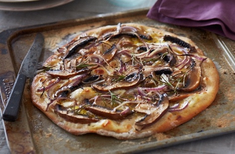 Impress your guests with this crowd-pleasing recipe and master the art of cooking a pizza on the barbecue. With its deliciously doughy homemade base and toppings of garlic mushrooms and fragrant red onions, it is sure to be a huge hit this summer. 