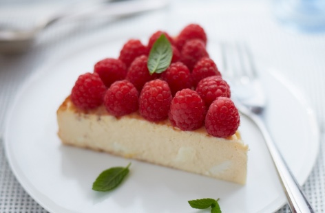 This delicate dessert topped with raspberries and mint misses out the traditional biscuit base and crust, and swaps sugar for sweetener to make a lower-sugar version of a lemon cheesecake.