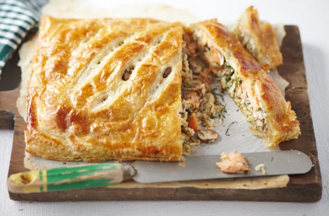 Coulibiac is a type of Russian pie, here stuffed with tender salmon chunks, fried rice, and delicious mushrooms. It's hearty yet light thanks to the aromatic lemon zest and dill. Bake until the pastry is a lovely golden brown and serve immediately.