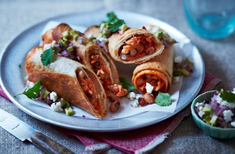 Get a taste of Mexico with these spicy rice and bean enchiladas. The heat comes from a combination of fresh red chilli and dried chilli powder, combining for a lip-tingling piquancy that's cooled by the creamy presence of feta cheese and avocado.