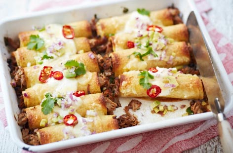 This Mexican-inspired recipe for spicy slow cooked pork enchiladas is a faff-free dinner that looks a lot more difficult than it actually is. All you've got to do is dress your pork shoulder steaks in honey, chicken stock, orange zest and juice before throwing them in the oven. Simple.