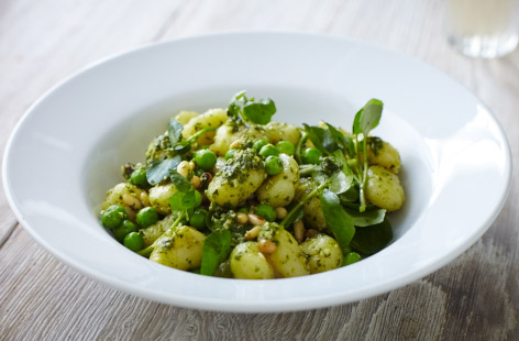 There are just five ingredients in this pea and pesto gnocchi for two. To make this quick and tasty lunch, pesto and pinenuts are stirred into cooked peas and gnocchi. Fold in beautiful blanched watercress leaves to add a peppery note to proceedings.