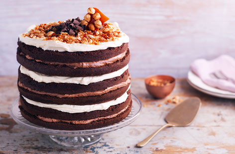 The ultimate chocolate showstopper that's guaranteed to impress your friends and family! This delicious layer cake is sandwiched with white chocolate icing and Nutella icing and topped with a super crunchy (and beautiful!) hazelnut praline