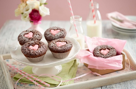 Make a batch of these adorable chocolate cupcakes, filled with pink buttercream, all packaged up with love.