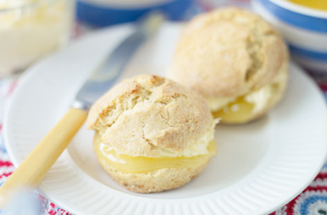 A citrus-heavy, zesty treat for family and friends to enjoy, this recipe for lemon scones with clotted cream is a pleasant twist on the classic scone. Lemon curd takes the place of strawberry jam in this perfect summer's day bake.