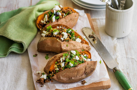 Mix up your jacket potato buffet bar with these loaded sweet potatoes. Stuffed with a steak mince filling, made with garlic, onion, spices and spinach and olives. Feta and parsley are stirred into the filling at the end. After all, it wouldn't be a baked potato without cheese.