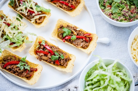These vegetarian mince tacos and guacamole are made with a delicious spice mix including chilli, cumin, oregano and paprika. The taco shells are packed with the mince, then topped with chunky guacamole, making every mouthful crunchy, creamy, zingy and spicy.