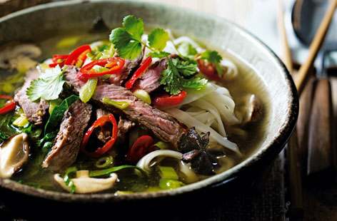 The key to making a good ramen at home is to spend time getting the flavours of the broth right. Here, star anise, ginger and miso paste in simmering water provide a fragrant base for the mushrooms and greens. It is poured into bowls after with cooked noodles, sliced steak, coriander and a chilli mixture.