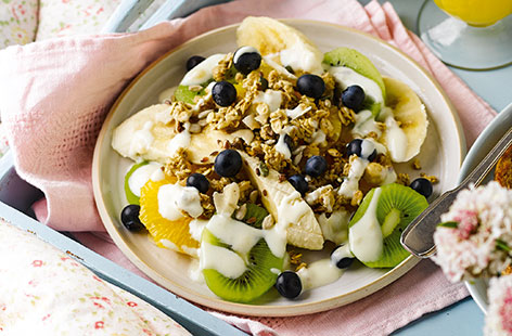 For a quick and easy Mother's Day breakfast try this fruit salad plate combining kiwi, orange, banana and blueberries and topping with fresh yogurt and crunchy granola