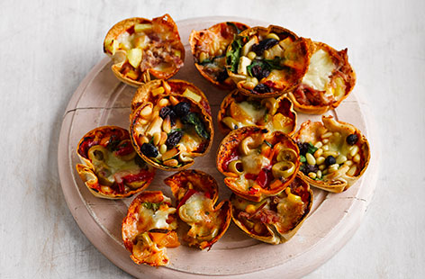 Bake a batch of these cute mini tortilla pizzas to keep the kids entertained during the school holidays. Start with a simple tortilla base and classic cheese and tomato toppings, then comes the fun part – the kids get to add whichever toppings they fancy