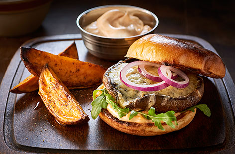 This marinated mushroom burger, filled with cheese and smoked paprika mayo and served with sweet potato wedges, will please even the most hardened meat eater.