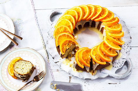 The perfect cake for an Easter celebration - delicious, light citrus sponge with a tangy citrus glaze, topped with pretty candied orange slices