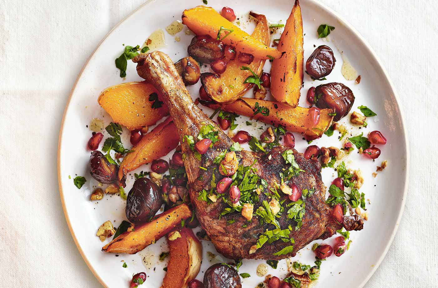 Five-spice duck legs with squash and pomegranate recipe
