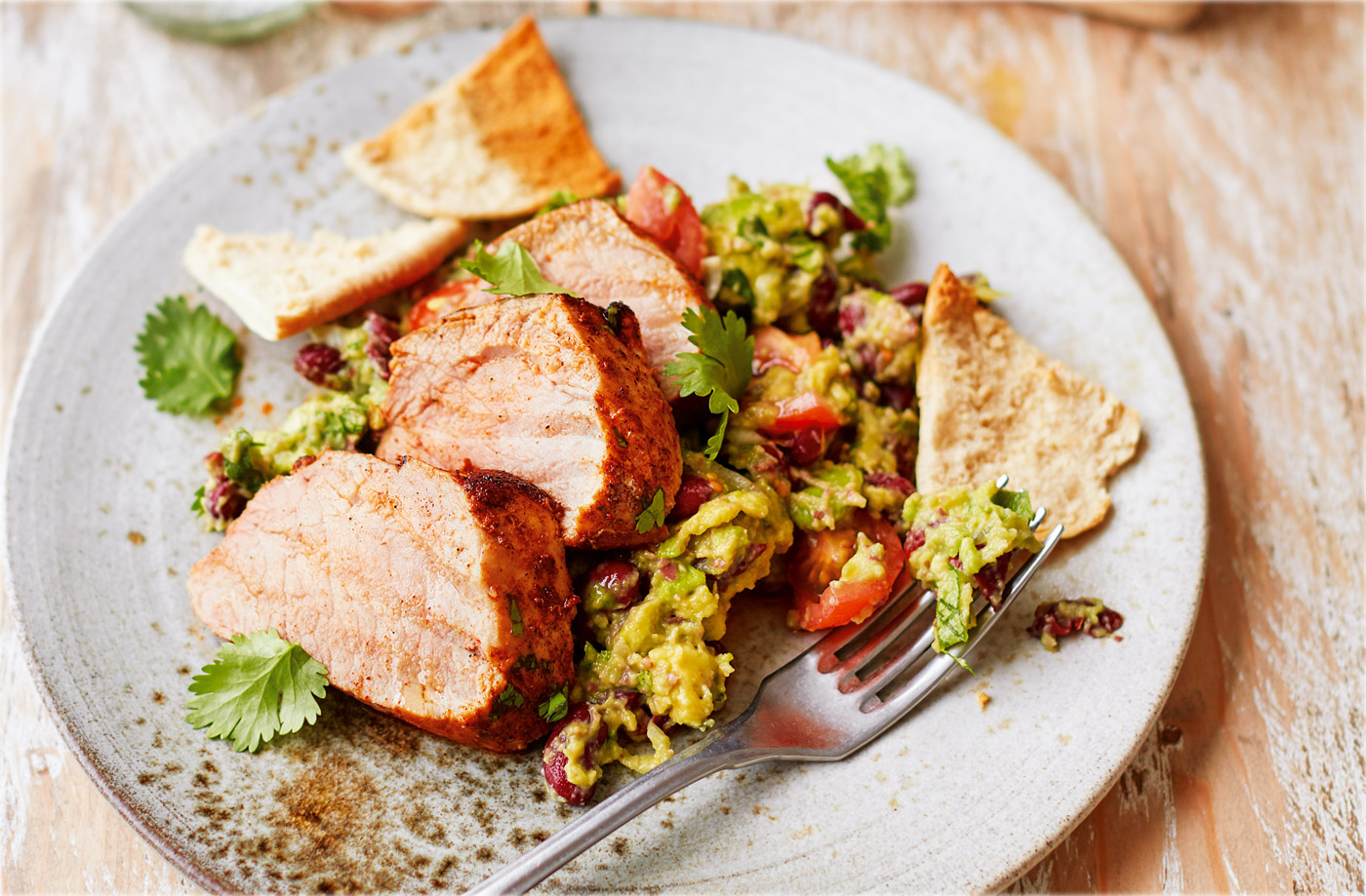 Spicy pork with chunky bean guacamole recipe
