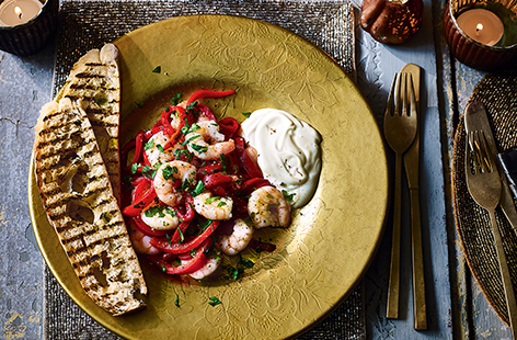 Roasted red peppers and stir-fried king prawns make a quick, easy dinner for two in this Mediterranean-style recipe