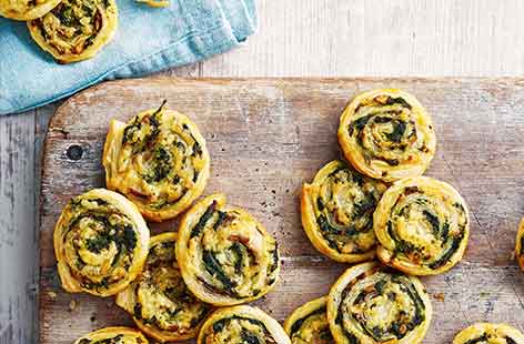 Golden puff pastry is rolled with veg and melting cheese for these pretty pinwheel snacks – dipped in tomato salsa for an extra treat