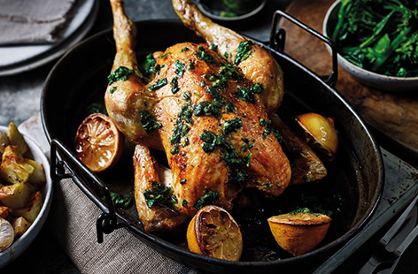 Give your next roast dinner a zesty, Mediterranean makeover with lemon, garlic and basil. Roasting the chicken and lemons together ensures wonderfully fragrant meat, while the sweet, roasted garlic flavours the crisp potatoes and basil salsa.