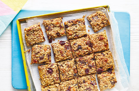 Golden chewy flapjacks are an irresistible teatime treat, and these flapjacks have been given an extra fruity twist with juicy grated pear, dried apricots and cranberries for a colourful traybake perfect for picnics.