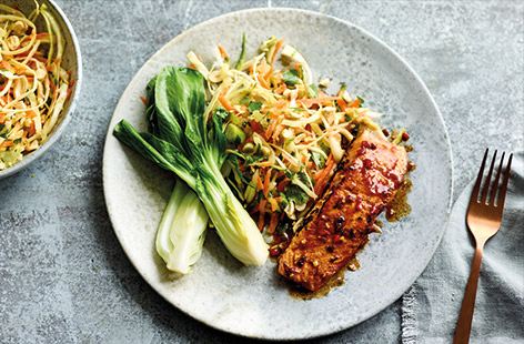 For a fast and healthy midweek dinner, try this speedy Asian-inspired salmon recipe. Sticky soy, ginger and chilli-marinated salmon is served with a crisp and colourful veggie slaw and tender pak choi for a flavour-packed meal ready in just 30 minutes.