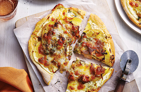 Dreaming of a takeaway? Satisfy your cravings with this easy homemade white pizza recipe instead. Top with caramelised onions, crispy bacon and thinly sliced potatoes before finishing with tangy blue cheese and oozy mozzarella for the ultimate cheese feast