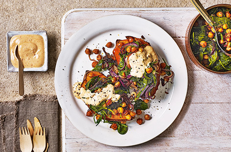 Load up earthy sweet potatoes with paprika-roasted chickpeas, wilted spinach and punchy harissa yogurt for a simple yet satisfying lunch for two