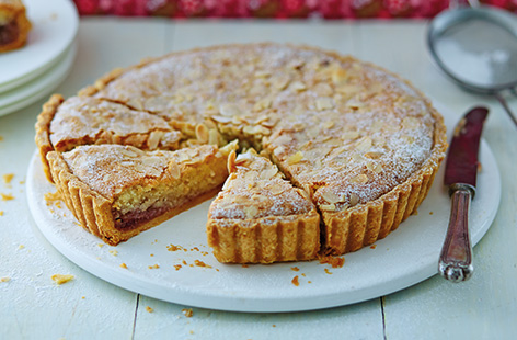 This fragrant almond tart is a classic British dessert and true family favourite. This traditional Bakewell tart recipe includes buttery homemade pastry with a thick layer of raspberry jam and a soft frangipane topping. 