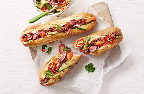 You only need one steak to make these two Vietnamese bahn-mi inspired baguettes. Juicy grilled meat, carved and stuffed in the bread with mayo, chilli sauce and lightly pickled carrot, cucumber and onion. It's garnished with fresh coriander leaves and sliced red chilli for oompf.