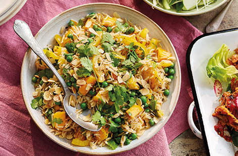 The flavours of coronation chicken have been transformed into a generous rice salad filled with peas, peppers and mango for a delicious colourful side dish – perfect for sharing.