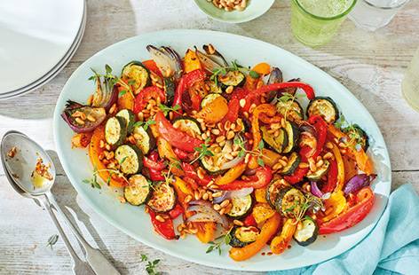 Serve up a taste of the Mediterranean with this warm roasted veg salad that makes a great side dish to grilled meats and fish or as part of a vegetarian buffet. Sweet, colourful roasted peppers and courgettes combine with a fragrant oregano and garlic oil.