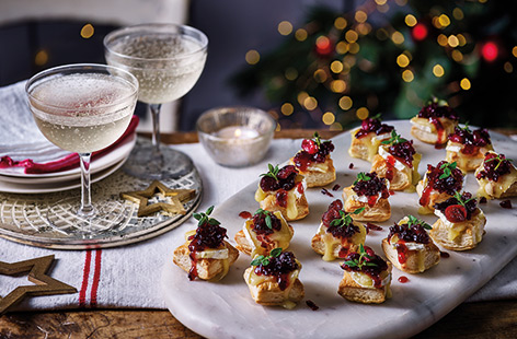 Combine classic festive flavours in this simple canapé recipe. A tangy homemade cranberry sauce and gooey, melting Camembert are layered on top of crisp puff pastry, perfect for Christmas parties.