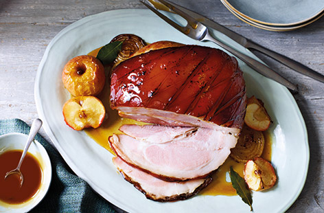 Feeding a crowd this Bonfire Night? Serve up this impressive roast gammon with sticky toffee apples and caramelised onions. A gammon joint is easy to carve and affordable, here simmered in apple juice for maximum flavour.
