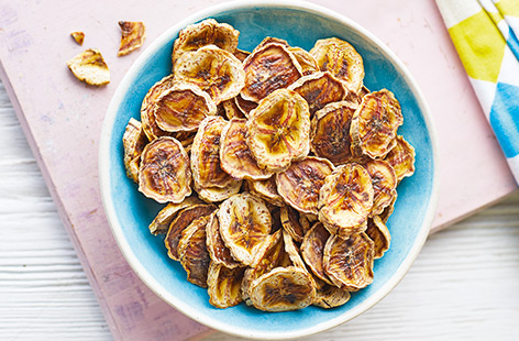 You need just four ingredients for these easy homemade banana chips. Sprinkled with ginger and cinnamon for a touch of spice, crunchy banana chips are cooked slowly in the oven until crunchy – make in big batches and pack up handfuls for a snack on-the-go.