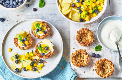Celebrate Easter weekend with a breakfast treat everyone will love. These cute granola nests act as little crunchy bowls for a yogurt and a tropical fruit salad topping, but you could substitute your own favourite fruits instead, if you like