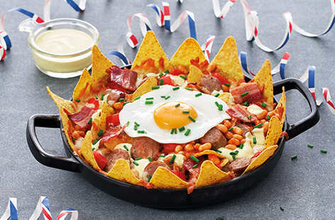 This ultimate nachos recipe brings all the flavours of a classic Full English to this indulgent Mexican snack. The nachos are layered with Cheddar, bacon, baked beans and sausages and topped with a fried egg for a brilliant finishing touch.