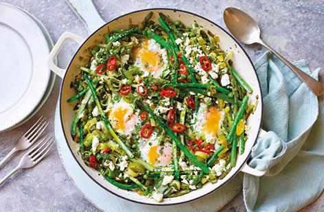 Make the most of fresh spring produce with this green twist on a classic shakshuka. Asparagus, peas and sweet leeks are baked with crumbled feta and eggs for perfect oozing yolks – the ideal veggie brunch recipe or easy one-pot meal.