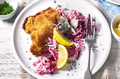Try this golden fried pork schnitzel recipe for a delicious midweek meal. Tender pork fillet, with a crisp golden crumb, is served with vibrant pink slaw combining smoky beetroot and crunchy radishes in a peppery mustard dressing