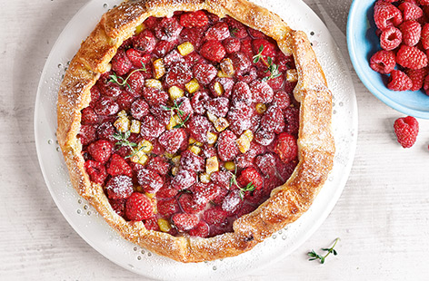 This simple raspberry galette recipe is the perfect summer dessert to enjoy in the sunshine. A galette is an easy French free-form tart, with crisp pastry encasing jammy baked raspberries and melting chunks of golden marzipan.