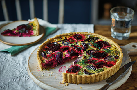 This beetroot quiche makes a brilliant vegetarian centerpiece for special occasions, such as Christmas Day or a Boxing Day buffet. With a crisp walnut pastry topped with bold beetroot and red onions, this versatile dish can be served hot or cold.