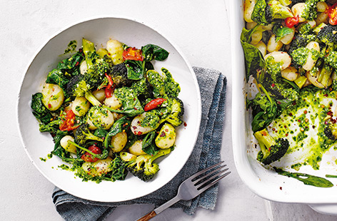 This simple traybake recipe combines pillowy gnocchi with broccoli, cherry tomatoes and spinach, all brought together with a herby homemade spinach pesto