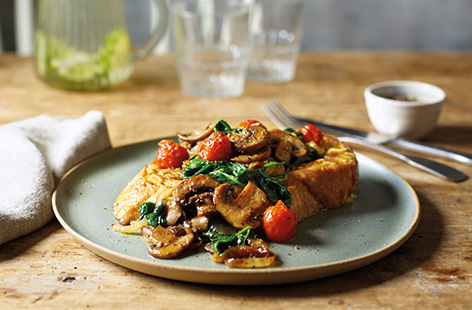 This savoury take on classic French toast is perfect for brunch at the weekend, or equally delicious as an easy midweek dinner. This budget recipe turns stale bread into a quick veggie meal with hearty mushrooms, caramelised onions and roasted tomatoes.