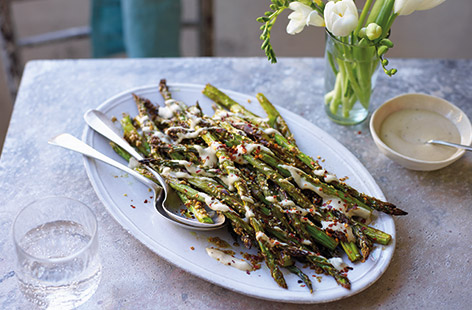 Make the most of seasonal British asparagus with this easy side dish. Delicate asparagus stems are simply roasted with a garlic and soy marinade and sesame seeds for a nutty crunch – delicious on its own or drizzled with the creamy tahini dressing.