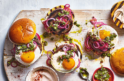 A quick red onion pickle, coriander salsa and a fried egg make this South-American style burger recipe stand out from the crowd. Cook them on the barbecue in summer, or on a griddle pan at any time of year.