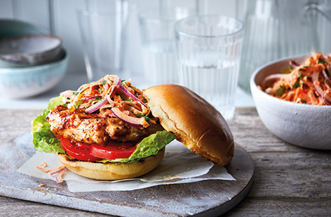 Give your traditional chicken burger recipe a healthy makeover with this Cajun-spiced version. Layer up these spicy burgers with smoky, griddled chicken breasts and crunchy carrot slaw in a soft brioche bun for a tasty family treat.