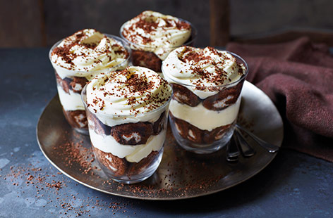 Chocolate mini rolls aren't just for kids – turn a packet into this easy cheat's tiramisu recipe for a simple yet elegant dessert. Coffee soaked mini rolls, soft mascarpone cream and a dusting of chocolate are sure to be a winner.